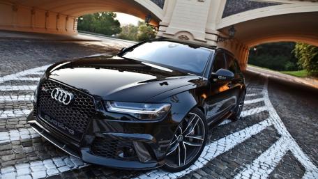 Sleek Black Audi on a Scenic Pathway wallpaper
