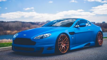 Blue Aston Martin with Stylish Bronze Rims wallpaper