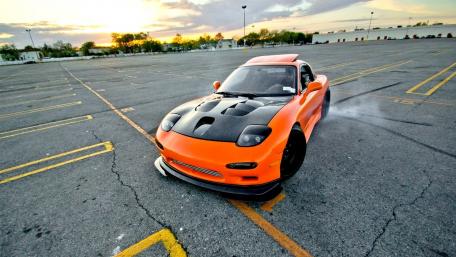Vibrant Orange Sports Car in Action wallpaper