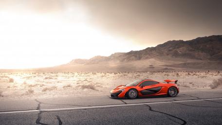 Sleek Orange Hypercar in a Desert Landscape wallpaper