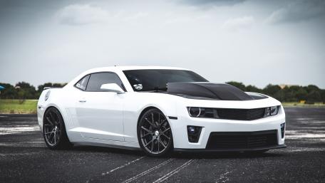 Sleek White Sports Car in Dramatic Setting wallpaper