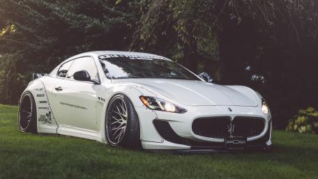 Sleek White Maserati on Lush Grassland wallpaper