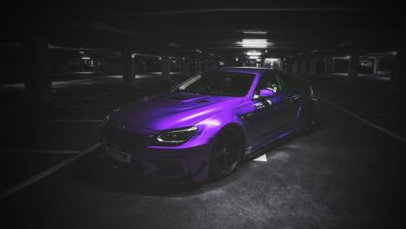 Stylish Purple Car in Dimly Lit Parking Garage wallpaper