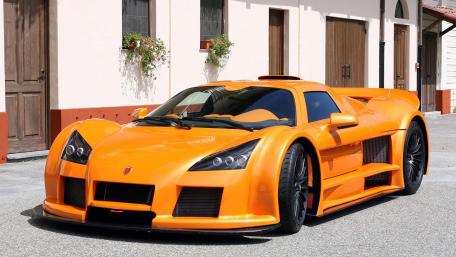 Stunning Orange Supercar on Display in the Sunlight wallpaper
