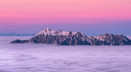Pink Sky Over Misty Mountain Peaks wallpaper