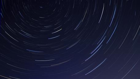 Ethereal Star Trails in Dark Night Sky wallpaper