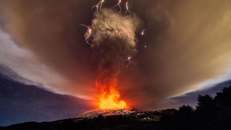 Majestic Volcanic Eruption Illuminated by Lightning wallpaper