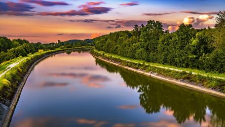 Serene River at Sunset with Colorful Reflections wallpaper
