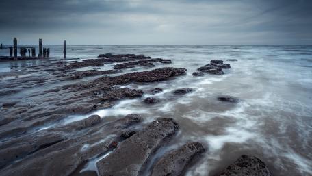 Serene Coastal Landscape in Soft Blue Tones wallpaper