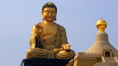 Golden Buddha Statue Surrounded by Tranquility wallpaper