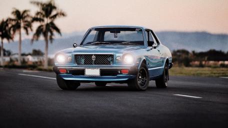 Classic Blue Car on Open Road wallpaper