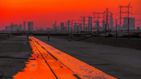 Stunning Sunset Over Urban Skyline With Power Lines wallpaper