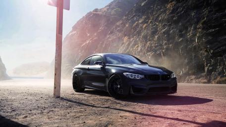 Sleek Black BMW on Mountain Road wallpaper