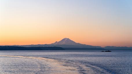 Serene Mountain Reflected in Calm Sea Waters wallpaper