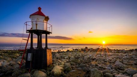 Elegant Watchtower at Sunset by the Shoreline wallpaper