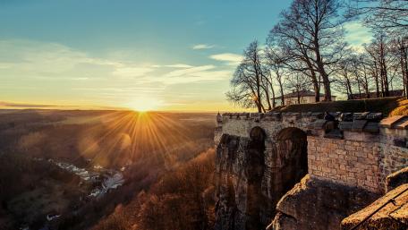 Golden Sunlight Over Serene Landscape wallpaper