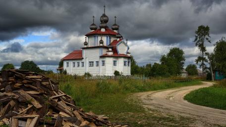 Wooden Church Beneath Stormy Skies wallpaper