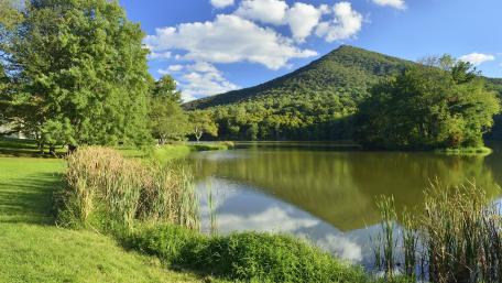 Serene Mountain Reflection on Tranquil Waterway wallpaper