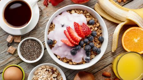 Delicious Breakfast Cereal Bowl with Fresh Berries and Yogurt wallpaper