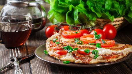 Delicious Fresh Pizza with Toppings and Greens wallpaper