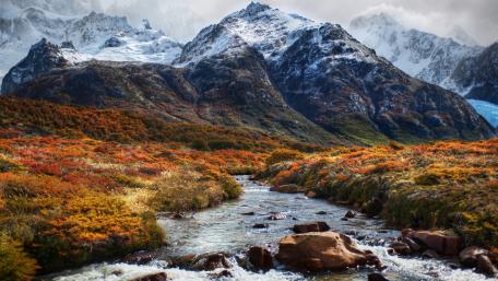 Majestic Mountains Surrounded by Vibrant Autumn Colors wallpaper