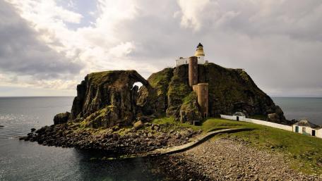 Majestic Lighthouse on Rocky Cliffside wallpaper