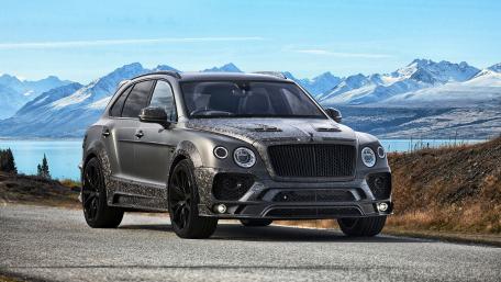 Sleek Luxury SUV Against Majestic Mountainscape wallpaper