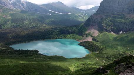 Breathtaking Mountain Tarn Overlooking Vibrant Lake wallpaper