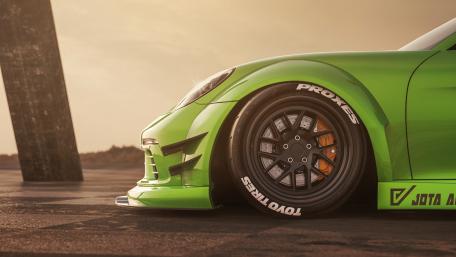 Sleek Green Speedster Basking in Sunset wallpaper
