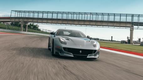 Sleek Ferrari Racing on the Track wallpaper
