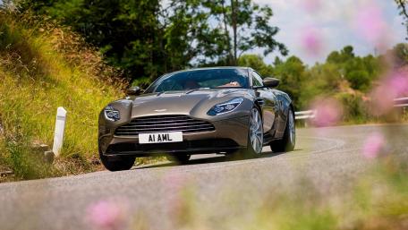 Sleek Aston Martin on a Scenic Road wallpaper