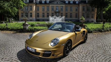 Golden Porsche Cabriolet in Luxurious Estate Setting wallpaper