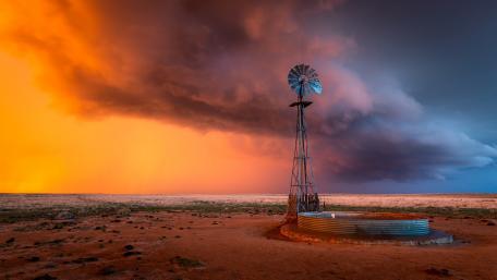 Majestic Stormy Skies Over a Field wallpaper