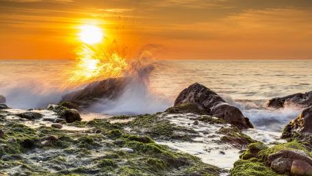 Golden Sunset Over Rocky Coastline wallpaper