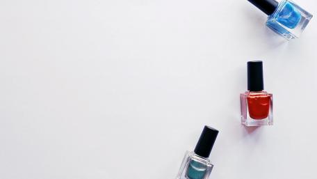 Vibrant Nail Polishes on a Clean Background wallpaper