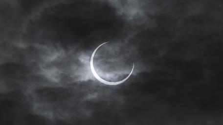 Mystical Crescent Moon Amidst Clouds wallpaper