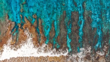 Vibrant Aerial View of Pristine Seashore Waves wallpaper
