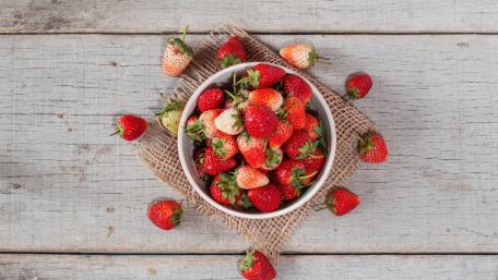 Fresh Strawberries in a Rustic Bowl wallpaper