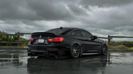 Sleek Black BMW Under Dramatic Skies wallpaper