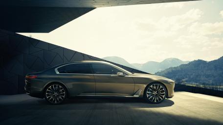 Sleek Luxury Car Against Scenic Mountainside View wallpaper