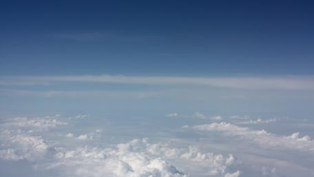 Endless Blue Sky with Fluffy Clouds Above wallpaper