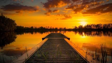 Serene Sunset Over Pier at Lake wallpaper