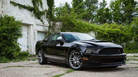 Sleek Black Muscle Car Wallpaper wallpaper