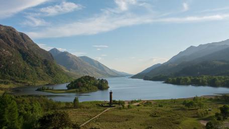 Serene Highland Landscape with Water and Mountains wallpaper