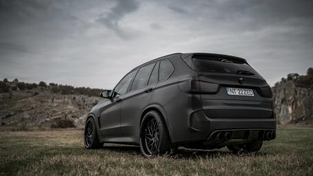 Sleek Black SUV on a Scenic Landscape wallpaper