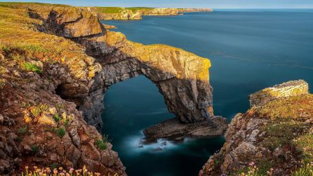 Majestic Coastal Arch Under Vibrant Sky wallpaper