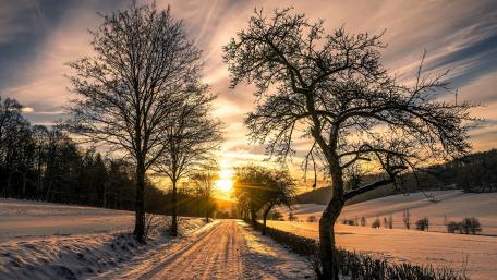 Winter Sunset Over Snowy Landscape wallpaper