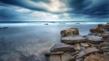 Serene Coastal Escape Amidst Dramatic Skies wallpaper