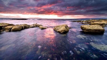 Tranquil Sunset Over Rocky Coastline wallpaper