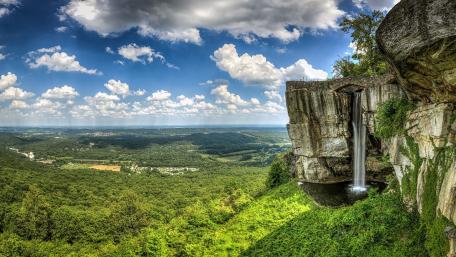 Majestic Waterfall Overlooking Lush Valleys wallpaper